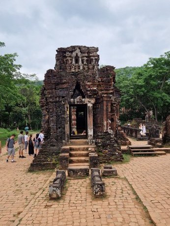 Stone courtyard and temple tower at My Son Sanctuary