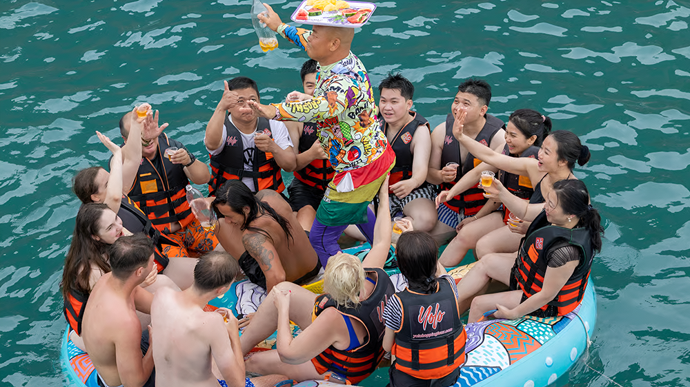 Entertainer serving fruit and drinks at the floating bar