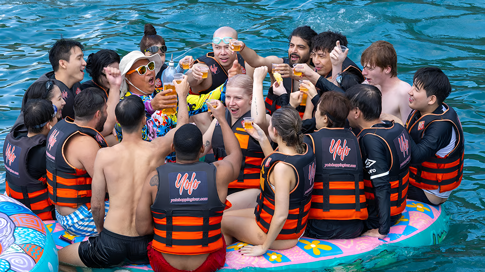 Group toasting drinks on the floating platform